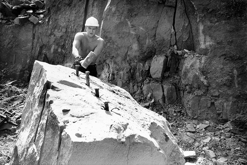 Quarryman splitting stone with plug and feathers Derbyshire Record Office Local Studies Collection